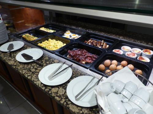 a buffet of food on a counter with plates at Hotel Am Kurpark Späth in Bad Windsheim