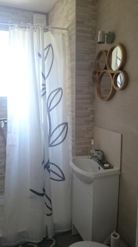 a bathroom with a white shower curtain and a sink at new rooms 3km to centrum in Gdańsk