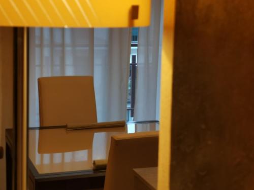 a room with a table and a chair and a mirror at Eschilo Luxury House in Carlentini