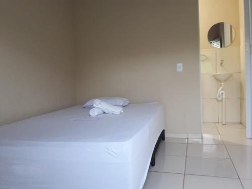 a bedroom with a white bed in a room at Pousada Alvorada in Riachão
