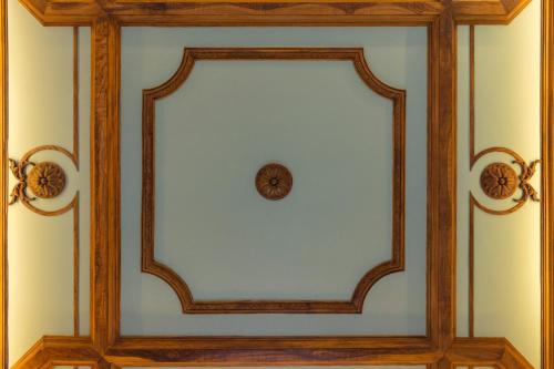 a clock in a wooden frame on a wall at O Paço - exclusive accommodation in Tomar