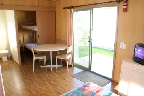a living room filled with furniture and a tv at Apollo Bay Holiday Park in Apollo Bay