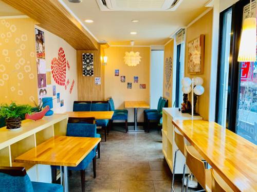 a restaurant with wooden tables and blue chairs at Tokyo Plaza Hotel in Tokyo