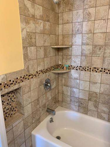 a bathroom with a bath tub and a sink at Sandy Shores Resort in North Wildwood
