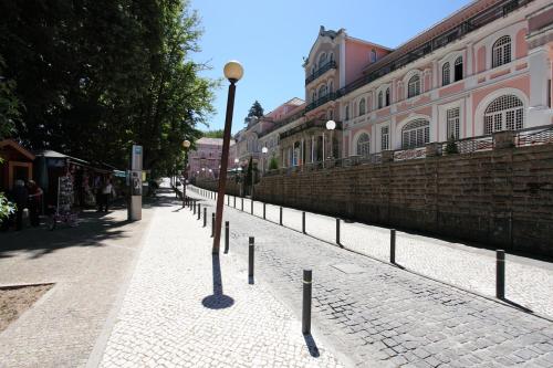 a street with a light pole on a sidewalk at INATEL Palace S.Pedro Do Sul in Termas de Sao Pedro do Sul