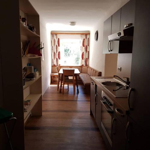 a kitchen with a table and a dining room at Amtmannhaus Ferienunterkunft in Irdning