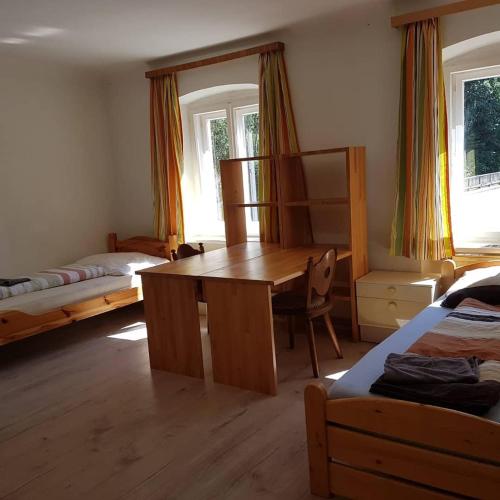 a bedroom with a desk and a bed and a table at Amtmannhaus Ferienunterkunft in Irdning