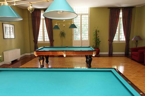a billiard table in a living room with a pool table at INATEL Palace S.Pedro Do Sul in Termas de Sao Pedro do Sul