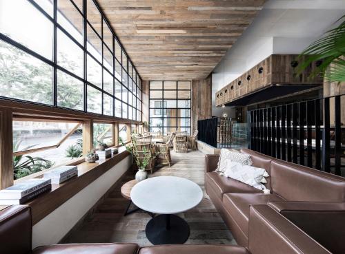 a living room with a couch and a table at Haikou S-INN Hotel in Haikou