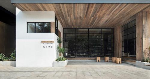 a lobby of a building with a wooden ceiling at Haikou S-INN Hotel in Haikou