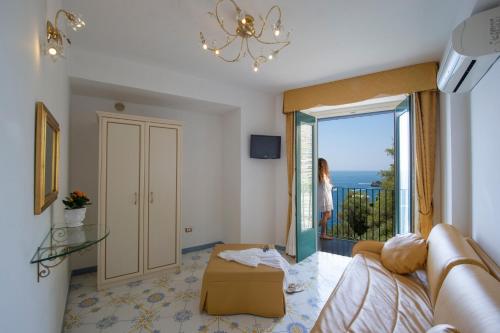 a living room with a couch and a view of the ocean at Hotel Villa Maria Pia in Praiano