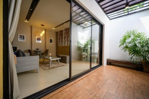 an open living room with sliding glass doors at Cae Villa Hua Hin in Hua Hin