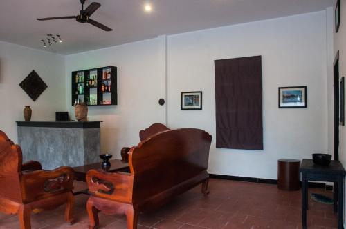 a living room with two chairs and a fireplace at Private Boutique Home with Pool, The Fin Angkor Boutique in Siem Reap