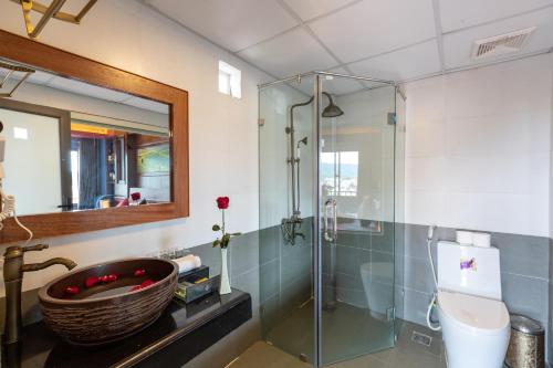 a bathroom with a sink and a glass shower at Saparis Hotel in Sa Pa