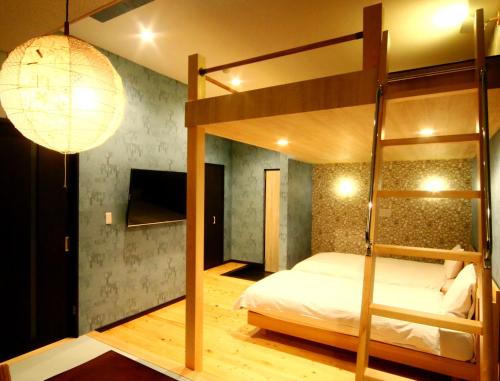 a bedroom with a bunk bed and a lamp at Amagiso in Kawazu