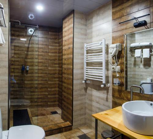 a bathroom with a sink and a shower at Resolute Shekvetili Hotel in Shekhvetili