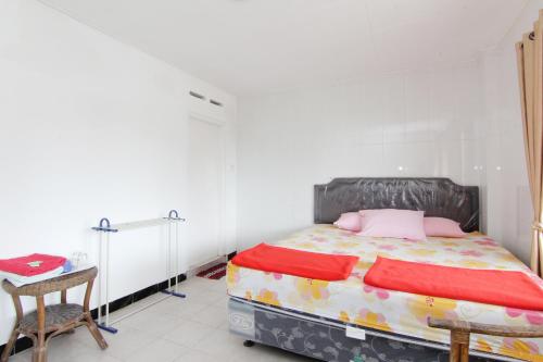 a bedroom with a bed and a table and a chair at Hotel Wijaya 1 Kaliurang in Yogyakarta