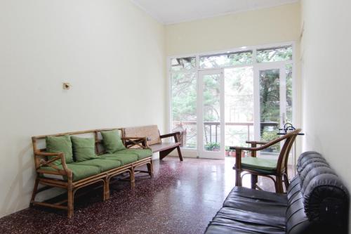 a living room with a couch and chairs at Hotel Wijaya 1 Kaliurang in Yogyakarta