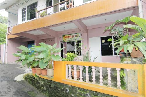 a building with plants in front of a store at Hotel Wijaya 1 Kaliurang in Yogyakarta