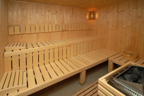 a sauna with wooden benches in a room at New Wolf in Bran