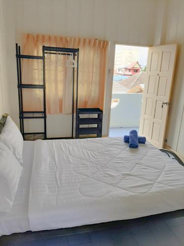 a bedroom with a large bed with a window at Plaza Huahin in Hua Hin