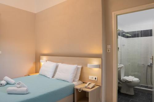 Ένα ή περισσότερα κρεβάτια σε δωμάτιο στο Talos Hotel Apartments 