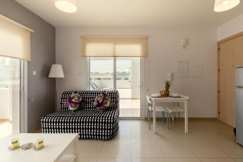 a living room with a couch and a table at Oceania Bay Village in Pyla