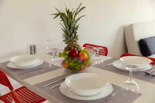 a table with a bowl of fruit on it at Oceania Bay Village in Pyla