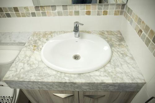 a bathroom sink with a white counter top at CUNIT HOME in Cunit
