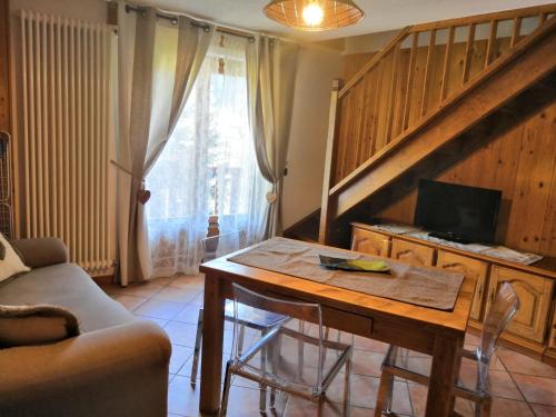 a living room with a table and a couch at Casa Alfredo in Cogne