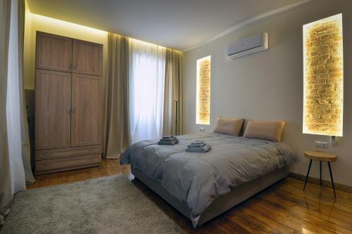 a bedroom with a large bed and a large window at Kouketa in Corfu