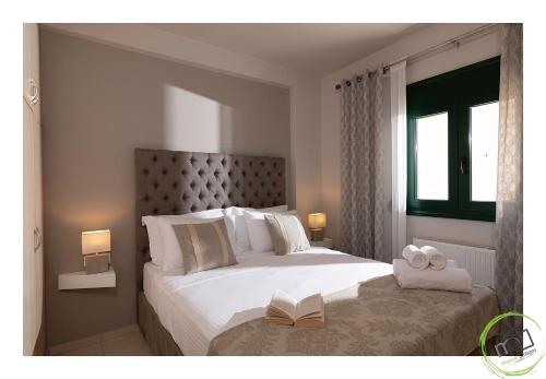 um quarto com uma cama com um livro em Irini Apartment Piskopiano, Hersonissos #2 em Hersonissos