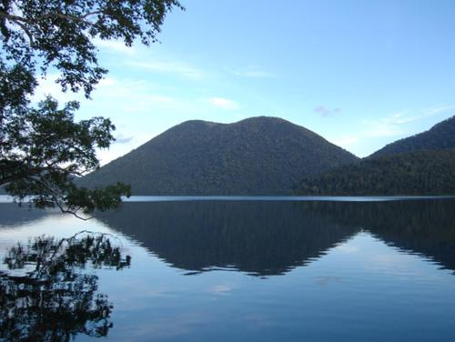a view of a lake with mountains in the background at Shikaribetsu Kohan Onsen Hotel Fusui in Shikaoi