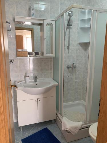 a bathroom with a sink and a shower at Kos Apartments in Bol