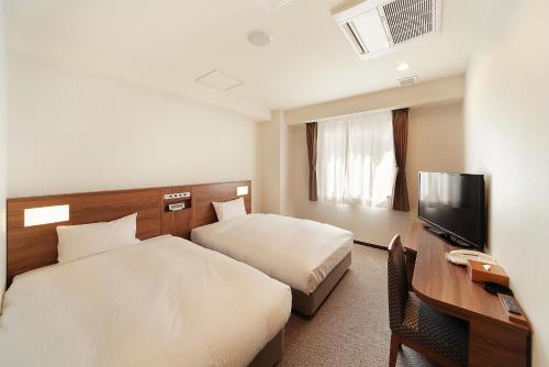 Tempat tidur dalam kamar di Toho Hotel Namba Motomachi