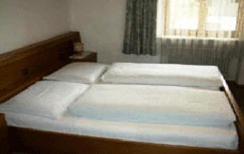 Ein Bett oder Betten in einem Zimmer der Unterkunft Guest House Peskoller