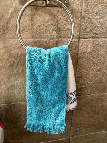 a blue towel is hanging on a towel rack at Hydra's View in Hydra
