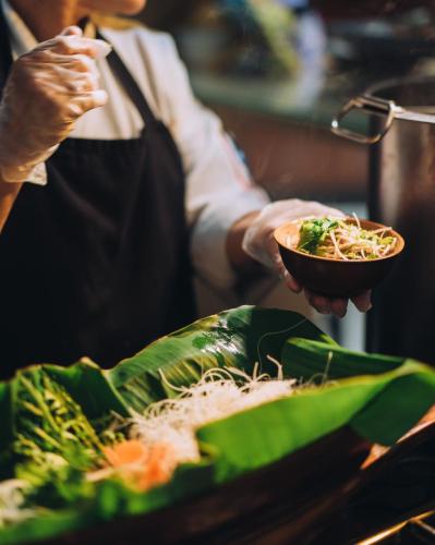 a person is holding a bowl of food at Dusit Thani Dubai in Dubai