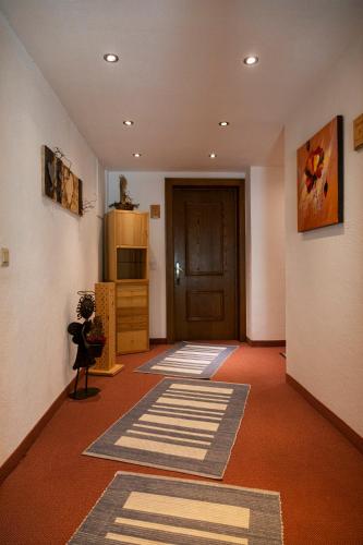 a room with a hallway with a door and carpet at Landhaus Gasser in Wenns
