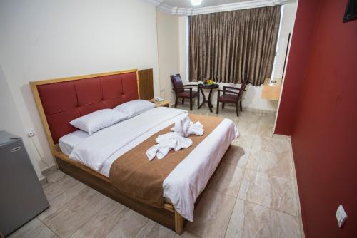 a bedroom with a large bed with towels on it at The Yacht Hotel in Aqaba