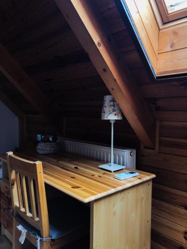a wooden desk in a room with a roof at Tulipános vendégház in Fertőszentmiklós