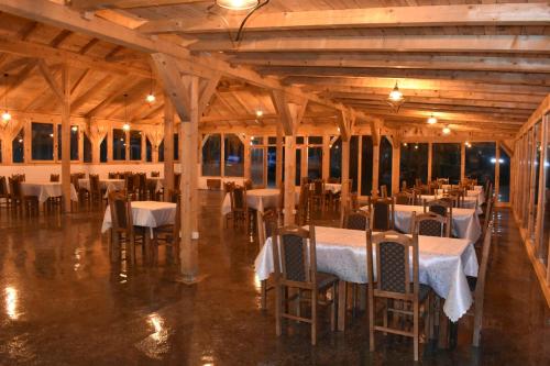 a dining room with tables and chairs in a building at TARA INN Resort in Bastasi