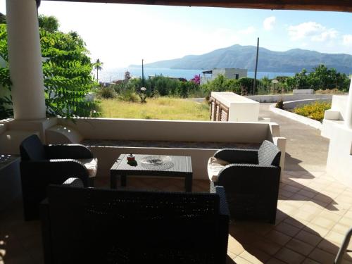 a patio with a couch and chairs and a table at Salina Case Vacanze in Santa Marina Salina