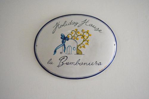 a plate with a picture of a toothbrush on a wall at La Bomboniera in Maiori