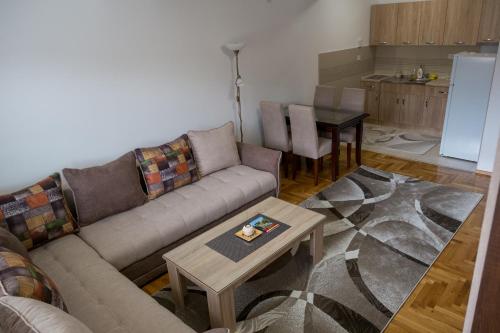 a living room with a couch and a table at Enjoy Apartments Karamach in Ohrid
