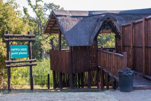 a playground with a wooden fence and a sign at Kruger Park Lodge Unit No. 612 in Hazyview