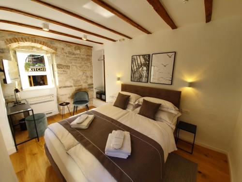 斯普利特的住宿－THE SUITES at central Split，一间卧室配有一张大床和毛巾