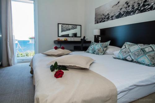 a bedroom with two beds with roses on them at Villas Arausana & Antonina in Vodice