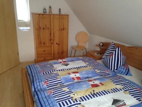 een slaapkamer met een bed met een quilt bij Ferienwohnung Kremer in Cuxhaven