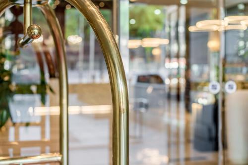 a close up of a gold railing in a store at Hotel Atrium Jongno in Seoul